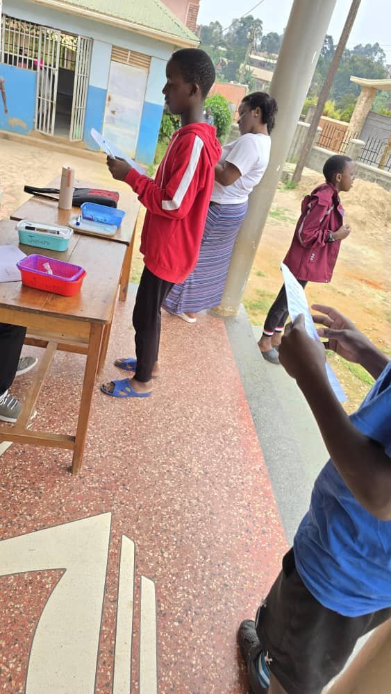 Children standing beside a table during an activity at 5 Day Club