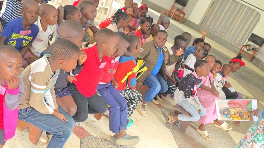 Children seated together with activity materials at 5 Day Club