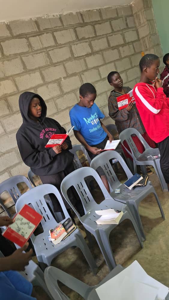 Children standing beside the church chairs during 5 Day Club