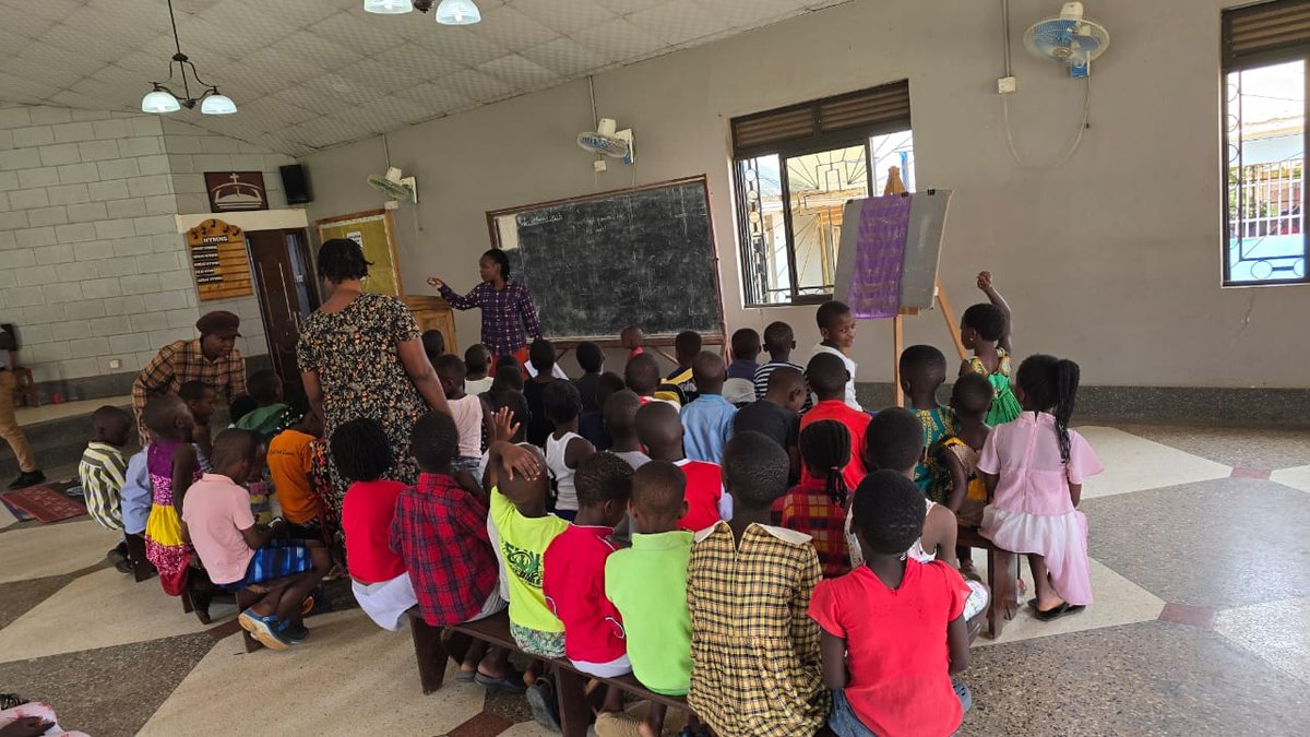 Children gathered around their leaders inside the church at 5 Day Club