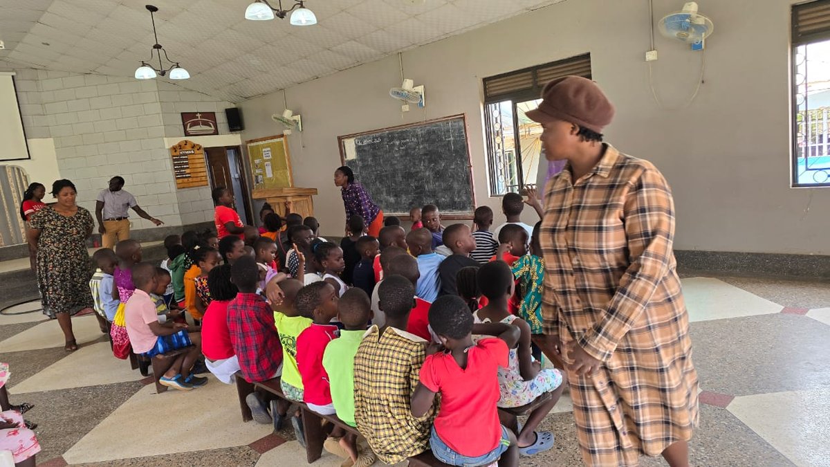 Children listening to a leader beside the chalkboard at 5 Day Club