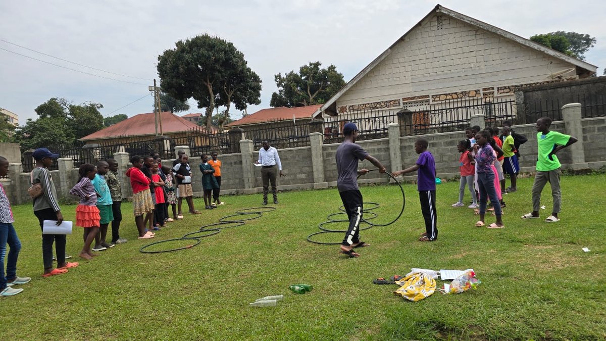 Children and leaders standing on the church lawn for a game at 5 Day Club