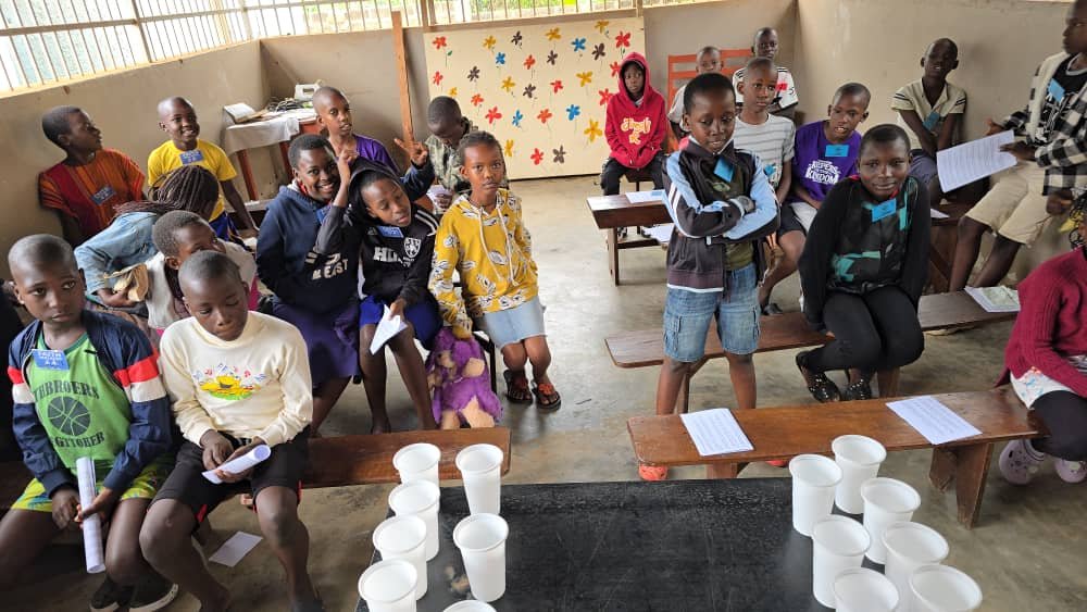 Children and leaders taking part in a group activity at 5 Day Club