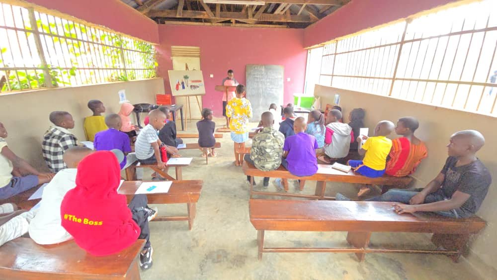 Children seated around tables with their leaders at 5 Day Club