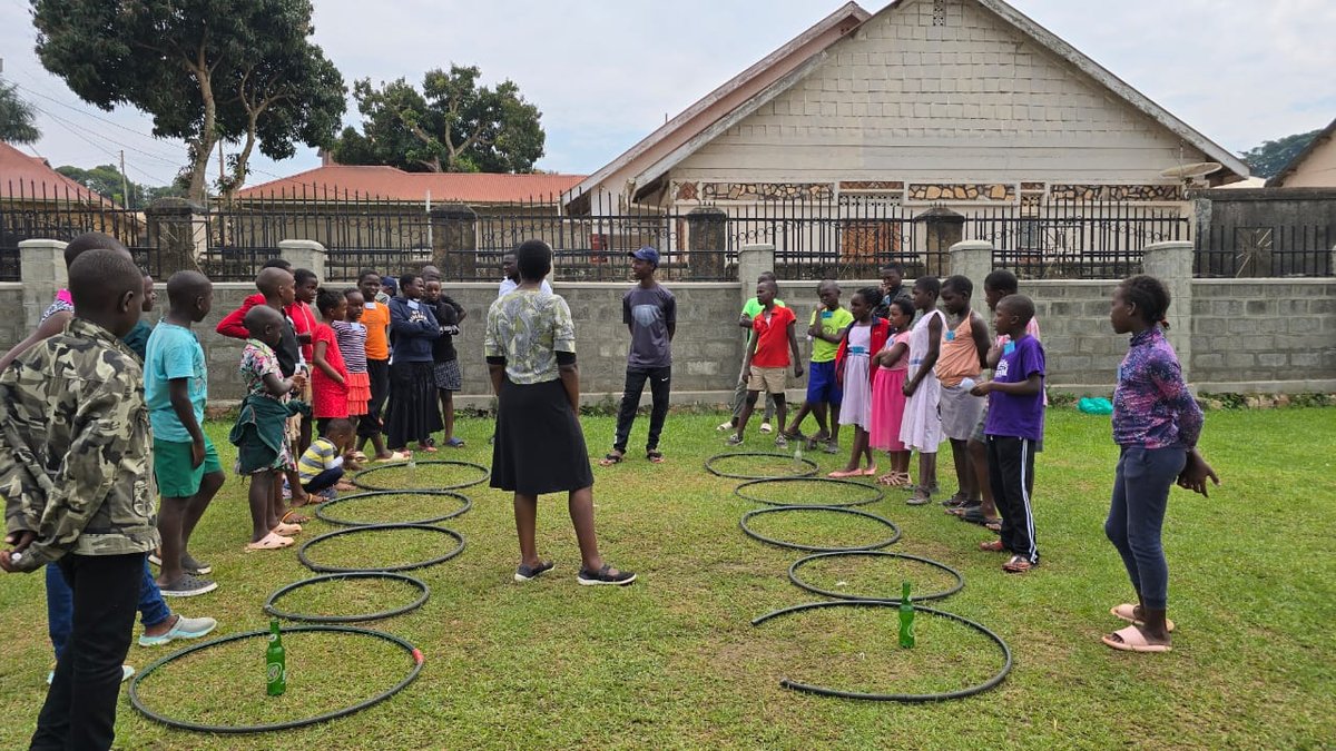 Children playing outdoor games on the church lawn at 5 Day Club