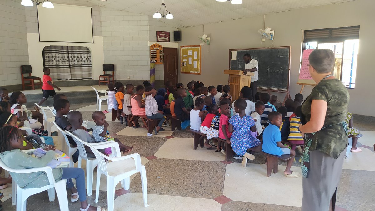 Children seated in the sanctuary with their leaders at 5 Day Club