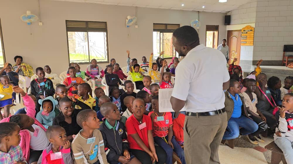 Children listening to a leader inside the church at 5 Day Club