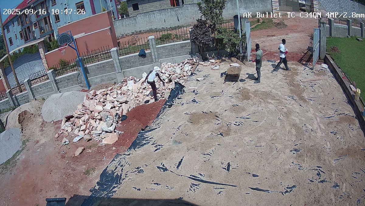 People working on a prepared surface beside paving stones in the church grounds