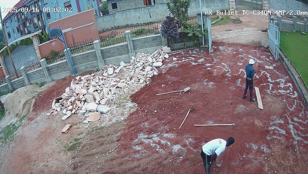 People working on the church grounds beside piles of paving stones